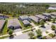 An aerial view of a neighborhood featuring water views, well-maintained lawns, and manicured landscaping at 4777 Ballantrae Blvd, Land O Lakes, FL 34638