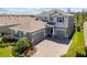 Aerial view of a two-story home with a three-car garage and a brick driveway with lush green landscaping at 4777 Ballantrae Blvd, Land O Lakes, FL 34638