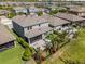 Aerial view showing the outdoor patio with landscaping, fencing, and neighborhood community around the property at 4777 Ballantrae Blvd, Land O Lakes, FL 34638