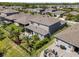 Backyard aerial view featuring a screened-in lanai, outdoor seating, and lush landscaping at 4777 Ballantrae Blvd, Land O Lakes, FL 34638