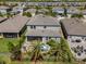Aerial view of backyard featuring palm trees, patio with outdoor seating, fire pit, and fenced-in yard at 4777 Ballantrae Blvd, Land O Lakes, FL 34638