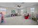 Spacious playroom with ample natural light, modern ceiling fan, and room to play at 4777 Ballantrae Blvd, Land O Lakes, FL 34638