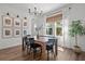 Elegant dining room with wood floors, chandelier, natural light, and decorative wall art at 4777 Ballantrae Blvd, Land O Lakes, FL 34638