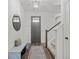 Inviting entryway with wood floors, stylish mirror, bench seating and a staircase with white risers at 4777 Ballantrae Blvd, Land O Lakes, FL 34638