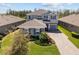 Charming two-story home featuring gray siding, manicured landscaping, and a paved driveway at 4777 Ballantrae Blvd, Land O Lakes, FL 34638