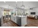 Open kitchen with stainless steel appliances, island, dining area, and living room; ideal for modern living at 4777 Ballantrae Blvd, Land O Lakes, FL 34638