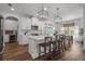 Open kitchen featuring white cabinetry, a large island with seating and modern pendant lighting fixtures at 4777 Ballantrae Blvd, Land O Lakes, FL 34638