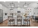 Bright, white kitchen featuring an island with bar seating and pendant lighting at 4777 Ballantrae Blvd, Land O Lakes, FL 34638