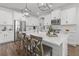 Bright, modern kitchen with stainless steel appliances, white cabinets and a large center island with seating at 4777 Ballantrae Blvd, Land O Lakes, FL 34638