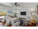 Cozy living room with shiplap accent wall, plush seating, and natural light from the patio doors at 4777 Ballantrae Blvd, Land O Lakes, FL 34638