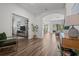 Open-concept living room with wood floors, an archway leading to a well-lit sitting room and modern furnishings at 4777 Ballantrae Blvd, Land O Lakes, FL 34638