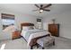 Cozy main bedroom featuring a wood-framed bed, two windows, and decorative wooden furniture at 4777 Ballantrae Blvd, Land O Lakes, FL 34638