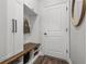 Well-organized mudroom featuring built-in cabinets, a bench with shoe storage, and a convenient coat rack at 4777 Ballantrae Blvd, Land O Lakes, FL 34638