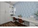 Bright home office featuring built-in storage, desk space, and a calming wallpaper design at 4777 Ballantrae Blvd, Land O Lakes, FL 34638