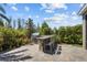 Outdoor kitchen with granite countertop and built-in grill in the backyard at 4777 Ballantrae Blvd, Land O Lakes, FL 34638