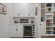 Well-organized butler's pantry with ample shelving, wine storage, and beverage cooler at 4777 Ballantrae Blvd, Land O Lakes, FL 34638