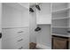 Spacious walk-in closet with ample shelving, drawers, and hanging rods for optimal organization at 4777 Ballantrae Blvd, Land O Lakes, FL 34638