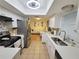 Bright kitchen features white cabinets, stainless appliances, light countertops and backsplash with recessed lighting and a ceiling fan at 523 Oakbriar Pl, Brandon, FL 33510