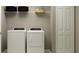 Laundry room with modern washer and dryer and ample storage space at 5622 Red Kite Dr, Wimauma, FL 33598