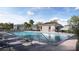 Upscale community pool with ample lounge seating, umbrellas, and a nearby cabana at 5622 Red Kite Dr, Wimauma, FL 33598