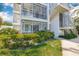 Exterior building view with manicured landscaping, stairwell access and multiple screened patios at 615 10Th Ne Ave # 1, St Petersburg, FL 33701