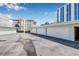 Condominium garages with parking lot surrounded by lush landscaping and blue skies at 615 10Th Ne Ave # 1, St Petersburg, FL 33701
