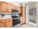 Modern kitchen with wood cabinets and stainless appliances and sliding glass doors to sunroom at 615 10Th Ne Ave # 1, St Petersburg, FL 33701
