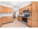 Spacious kitchen area with wood cabinets and stainless steel appliances with access to the dining area at 615 10Th Ne Ave # 1, St Petersburg, FL 33701