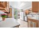 Well-lit kitchen with white appliances, wood cabinets, and easy access to the patio at 615 10Th Ne Ave # 1, St Petersburg, FL 33701