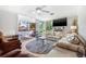 Spacious living room featuring a ceiling fan, sliding glass doors, and comfortable seating at 615 10Th Ne Ave # 1, St Petersburg, FL 33701