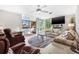Spacious living room featuring a ceiling fan, sliding glass doors, and comfortable seating at 615 10Th Ne Ave # 1, St Petersburg, FL 33701