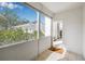 Enclosed porch offers natural light and a view of the surrounding greenery at 615 10Th Ne Ave # 1, St Petersburg, FL 33701