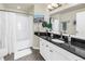 Well-lit bathroom features dark countertops, white cabinets, and a combined bathtub and shower at 700 S Harbour Island Blvd # 231, Tampa, FL 33602