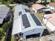 Close up aerial shot highlighting the property with solar panels and a shingle roof at 753 Almeda N St, St Petersburg, FL 33702