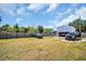 A spacious backyard with a parking area, basketball hoop, and well-maintained grass at 753 Almeda N St, St Petersburg, FL 33702