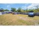 Spacious backyard featuring grass, a privacy fence, and a parked car, ideal for outdoor activities at 753 Almeda N St, St Petersburg, FL 33702