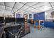 Finished basement showcasing sports-themed decor, table with stools, and space for a home office or entertainment area at 753 Almeda N St, St Petersburg, FL 33702