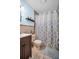 Bathroom with a vanity, toilet, and patterned shower curtain at 753 Almeda N St, St Petersburg, FL 33702