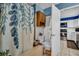 Bright bathroom featuring a tiled shower with curtain and an adjacent kitchen, offering convenience and functionality at 753 Almeda N St, St Petersburg, FL 33702