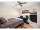 Cozy bedroom featuring a ceiling fan, wooden floors, and natural light from the window at 753 Almeda N St, St Petersburg, FL 33702