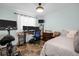 Comfortable bedroom with a desk setup, light blue walls, and large window, perfect for work or relaxation at 753 Almeda N St, St Petersburg, FL 33702
