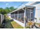 An exterior view of the screened patio with plants, showing its integration with the home's structure at 753 Almeda N St, St Petersburg, FL 33702