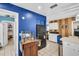 Well-lit kitchen with stainless steel appliances, blue accent wall, and ample storage space at 753 Almeda N St, St Petersburg, FL 33702
