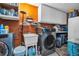 Laundry room with sink, washer, dryer, and storage cabinets at 753 Almeda N St, St Petersburg, FL 33702