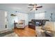 Inviting living room with hardwood floors, comfortable seating, and a decorative fish wall hanging at 753 Almeda N St, St Petersburg, FL 33702