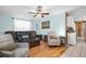 Bright living room with hardwood floors, ceiling fan, and comfortable seating arrangement at 753 Almeda N St, St Petersburg, FL 33702