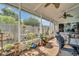 Enclosed patio featuring a seating area, plants, and large windows with views of the backyard at 753 Almeda N St, St Petersburg, FL 33702