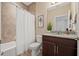 Cozy bathroom featuring granite countertop vanity, decorative tile, a shower-tub combo, and neutral colors at 8078 Pine Crest St, Seminole, FL 33777