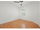 Bright bedroom featuring hardwood floors, a ceiling fan, and a window with shutter style blinds at 8078 Pine Crest St, Seminole, FL 33777