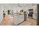 Open kitchen with stainless appliances, an island, and a view of the living room and lanai at 8078 Pine Crest St, Seminole, FL 33777